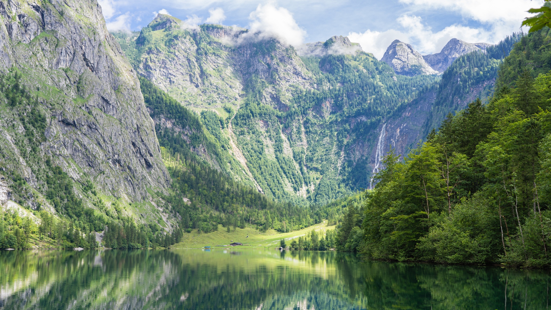 High mountains by the lake with green trees