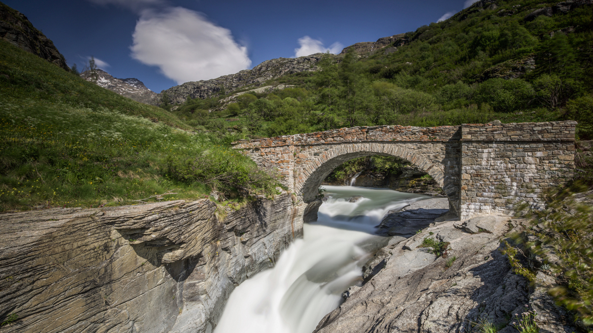 Stone bridge over the river in the mountains