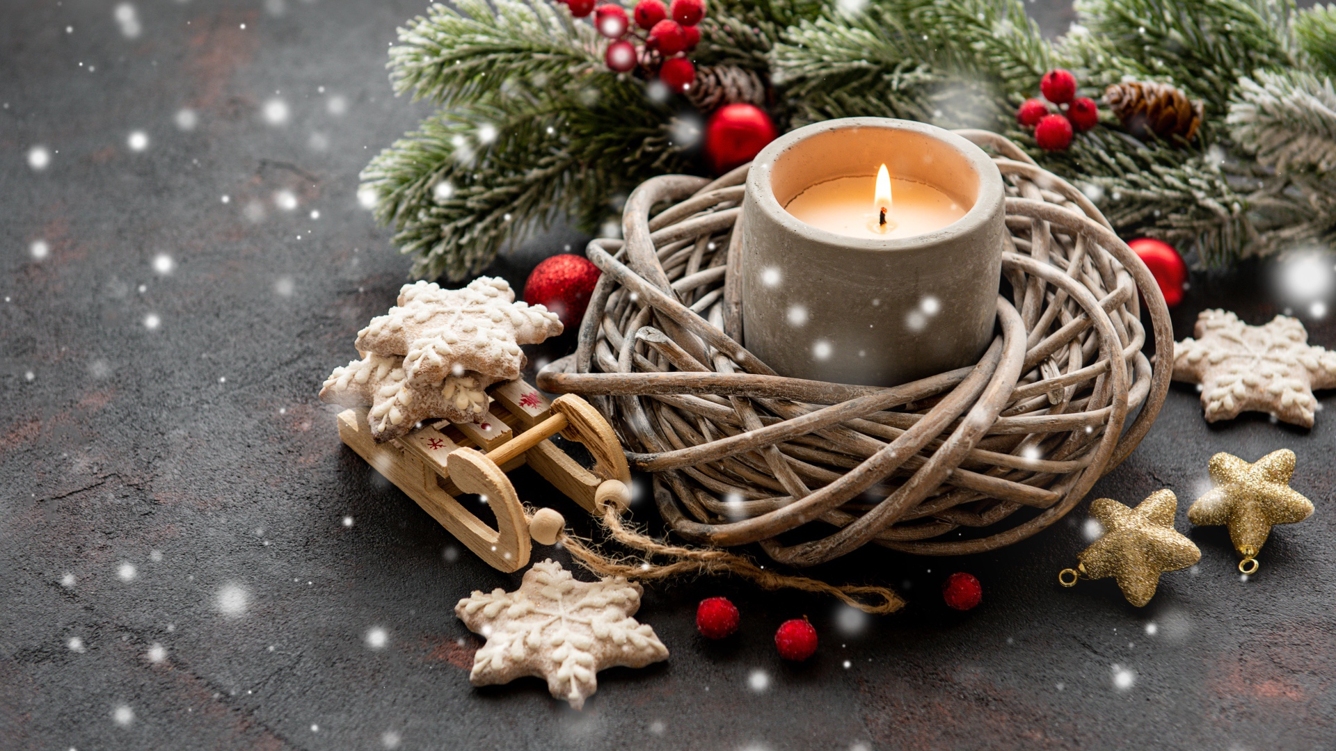 Lighted candle with fir branch and decorations