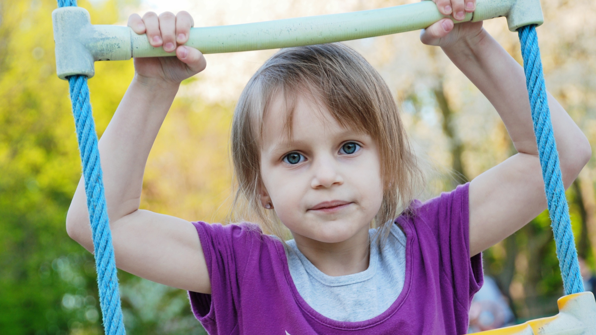 Маленькая девочка на подвесной лестнице 
