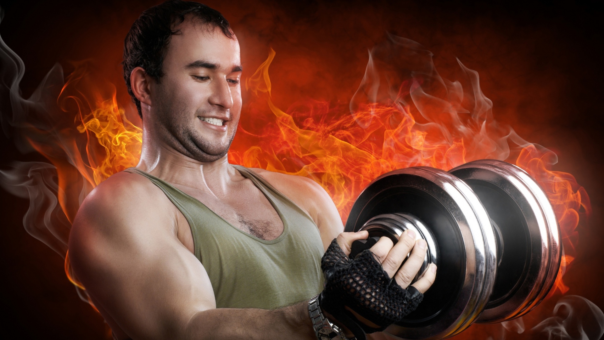 Накаченный мужчина с гантелей в руках на фоне огня 