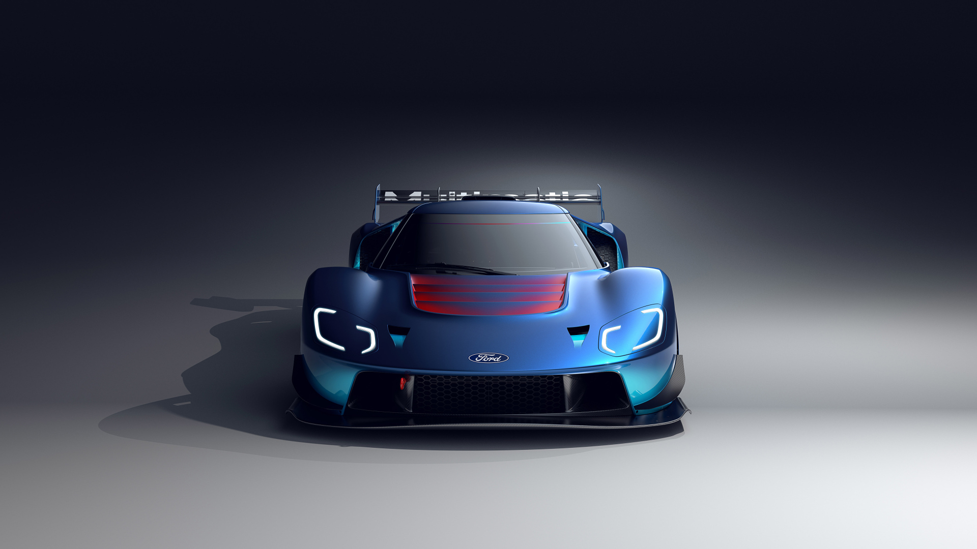 Синий автомобиль Ford GT MkIV 2023 на сером фоне
