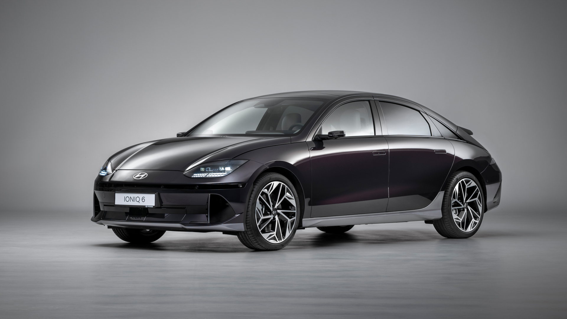 Черный автомобиль Hyundai IONIQ 6 2022 года на сером фоне