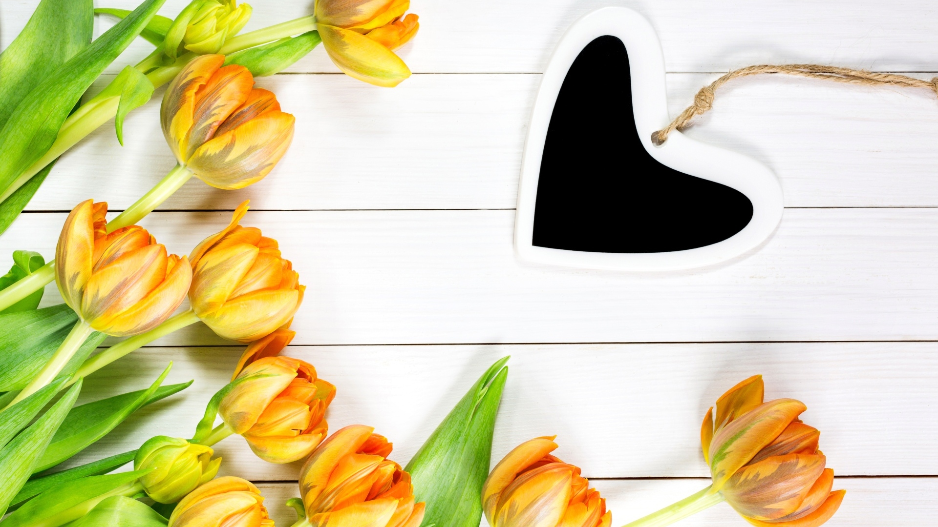 Букет оранжевых тюльпанов с сердцем на белом столе