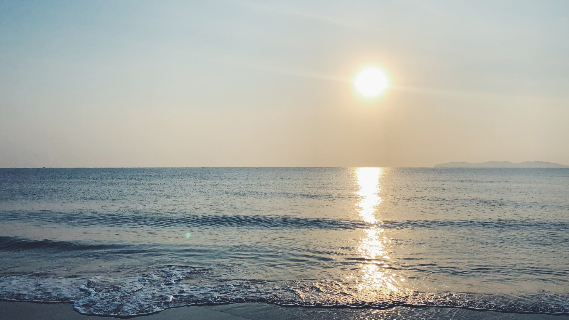 Яркое солнце над спокойным морем летом