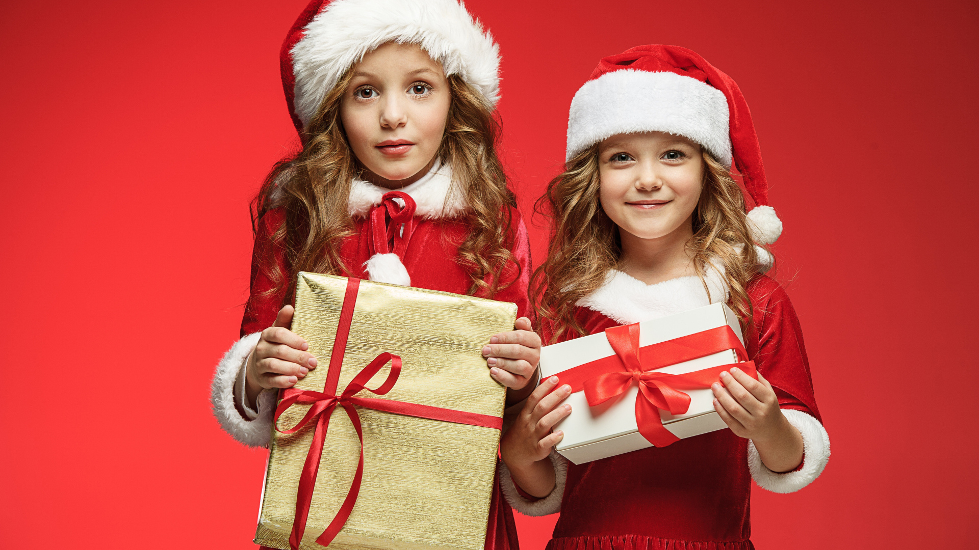 Две маленькие девочки с подарками на Рождество