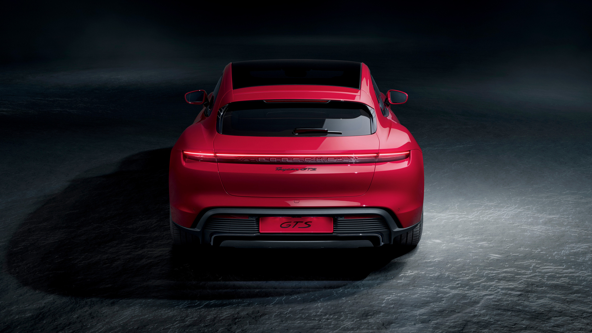 Красный автомобиль Porsche Taycan GTS  вид сзади