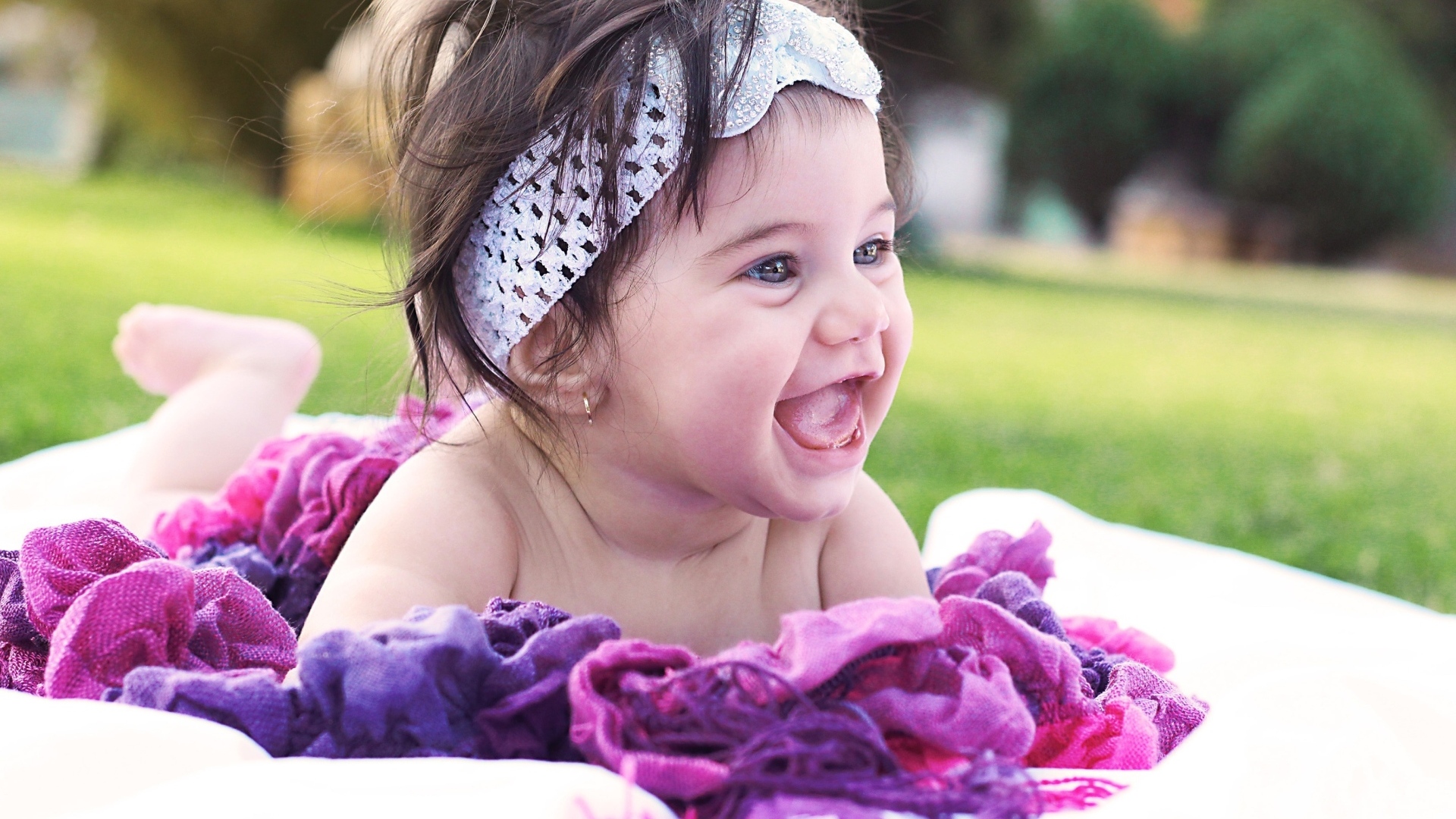 Улыбающаяся маленькая девочка с повязкой на голове 