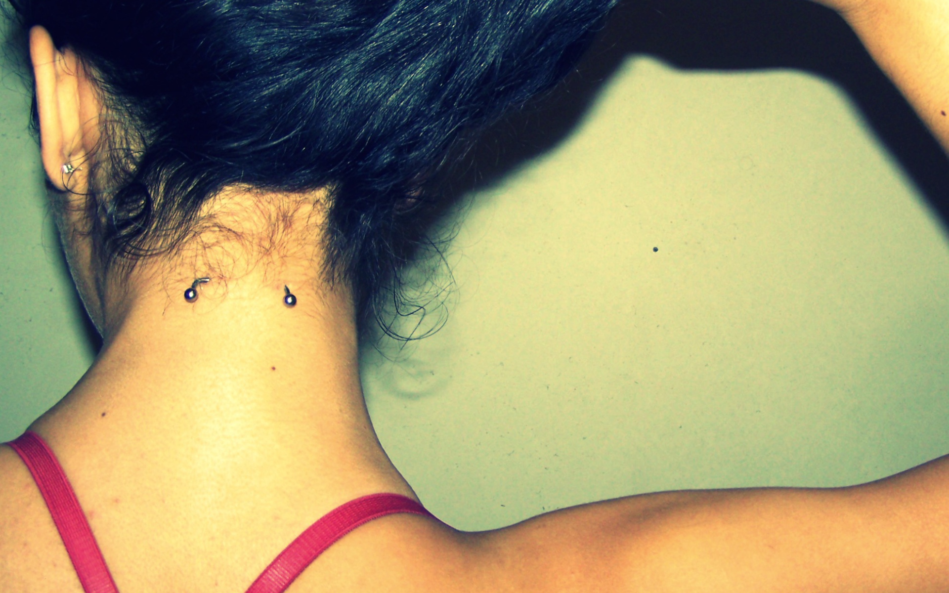 Девушка брюнетка с пирсингом в шее