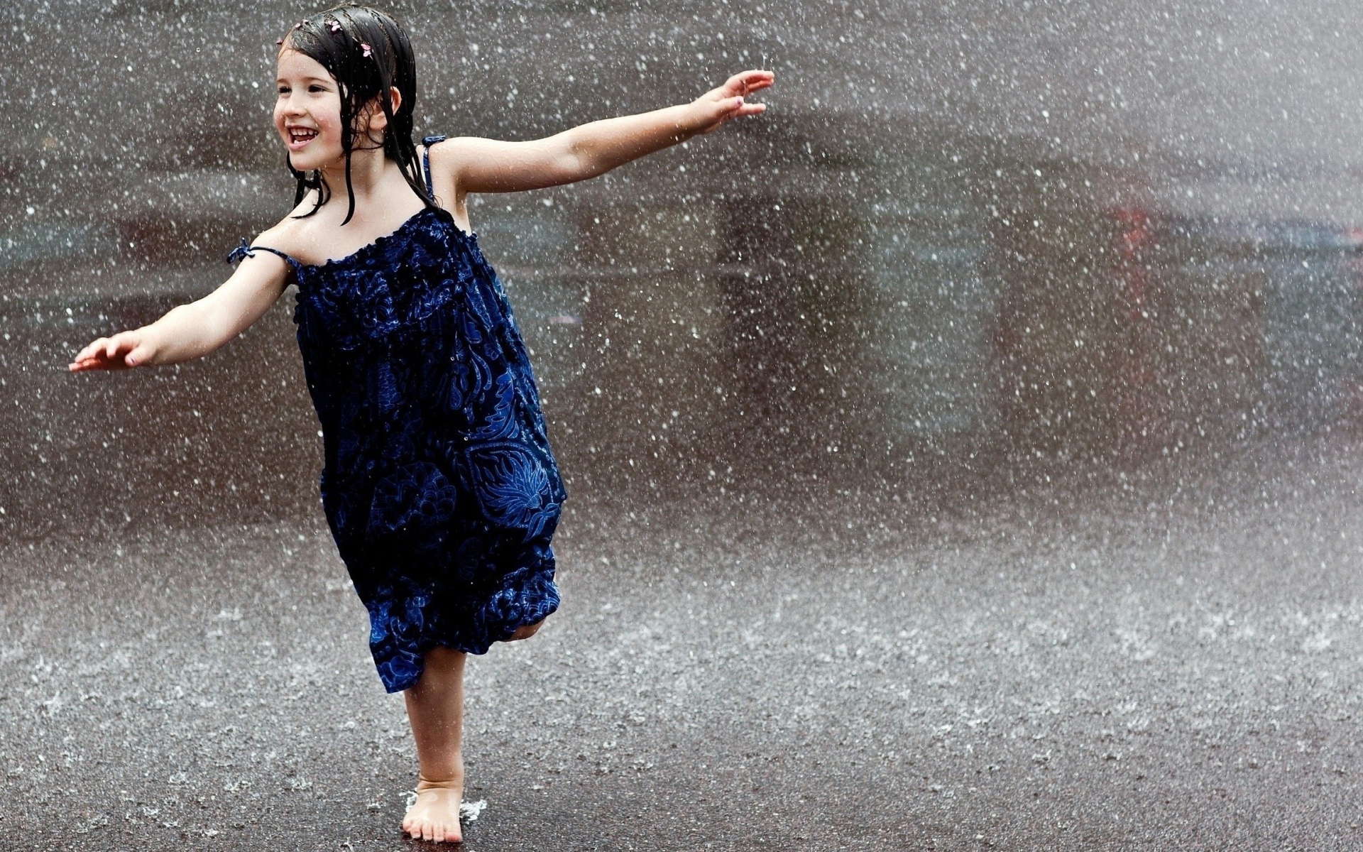 Счастливый ребенок бегает под дождем