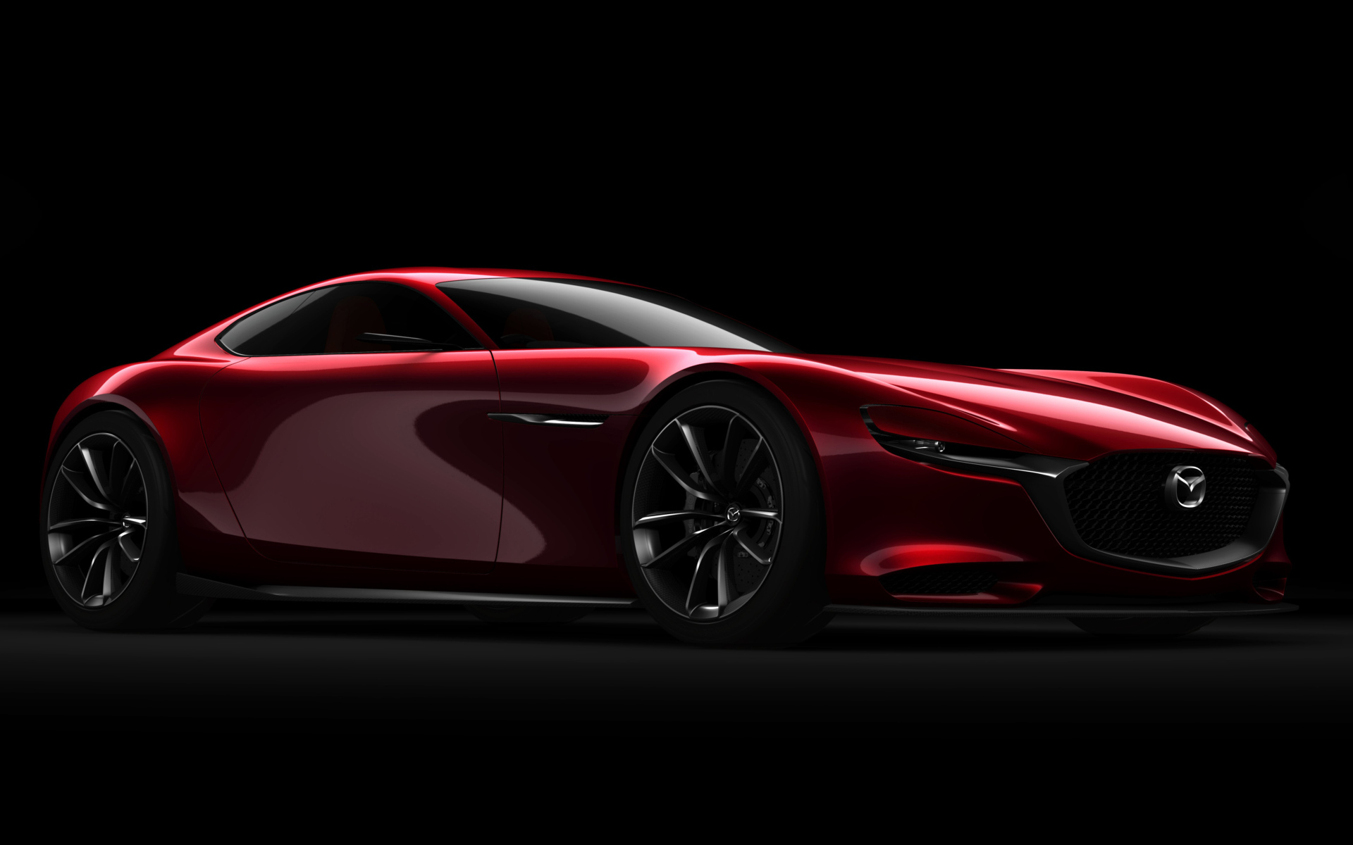 Красный спортивный автомобиль Mazda RX Vision Concept на черном фоне