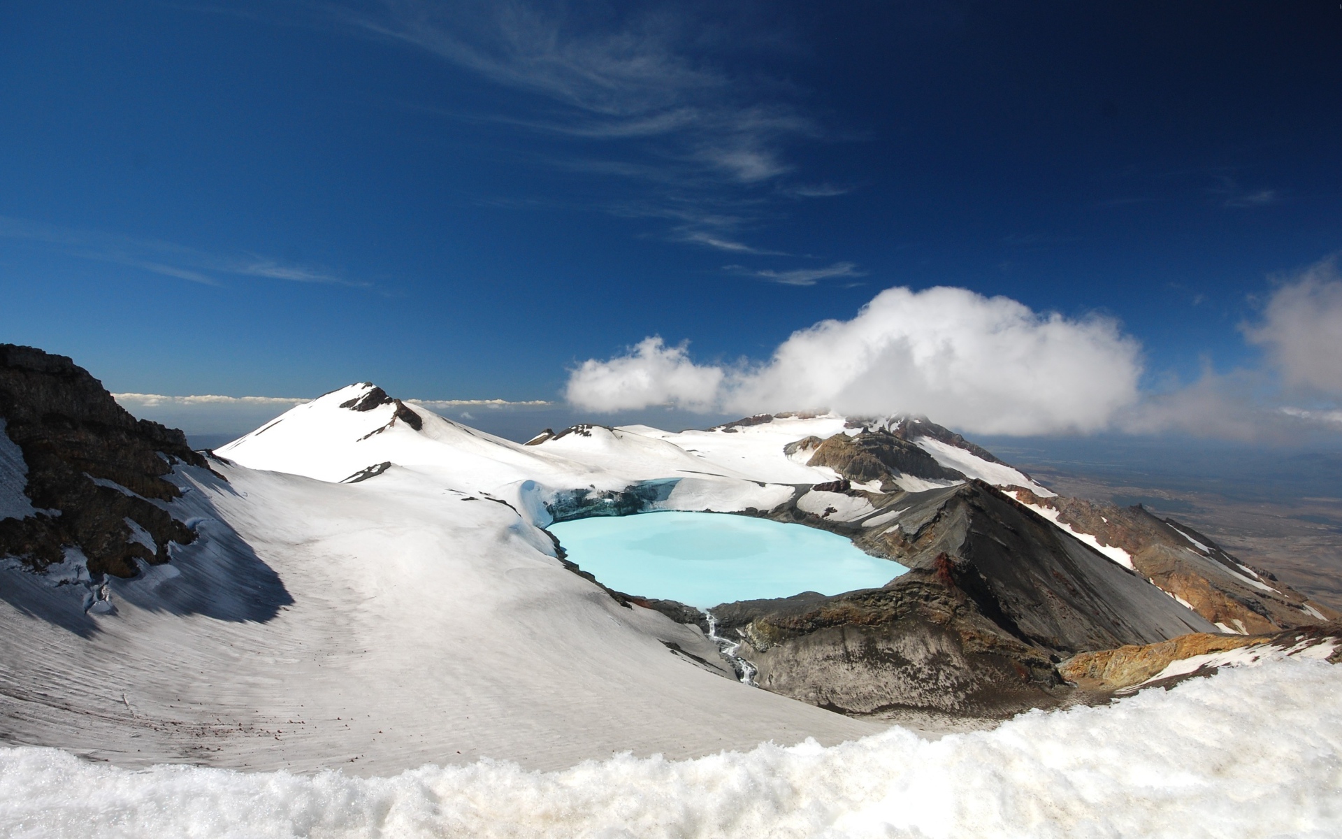 Snow-covered crater of Tongariro volcano under the blue sky, New Zealand