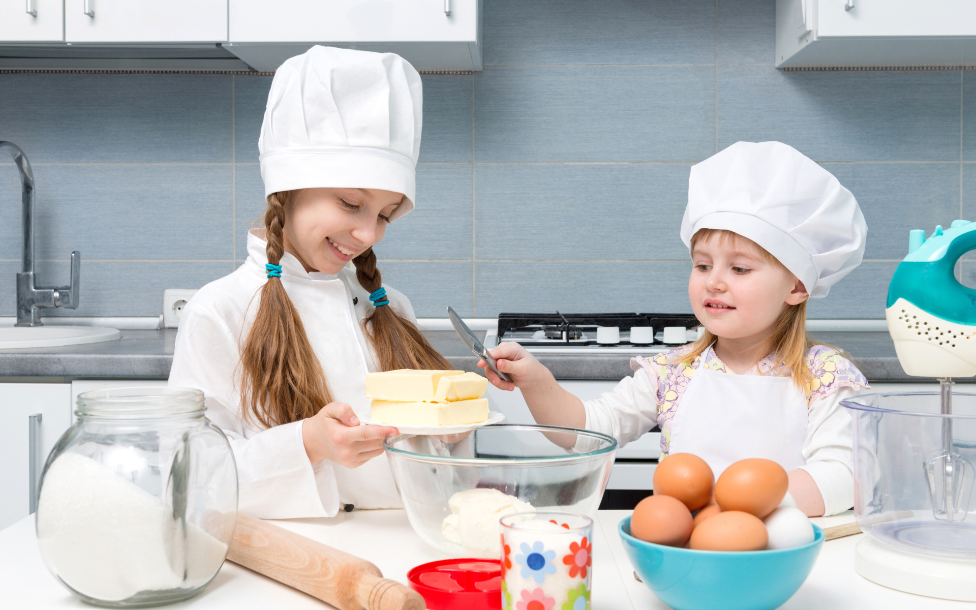 Две маленькие девочки на кухне готовят пирог