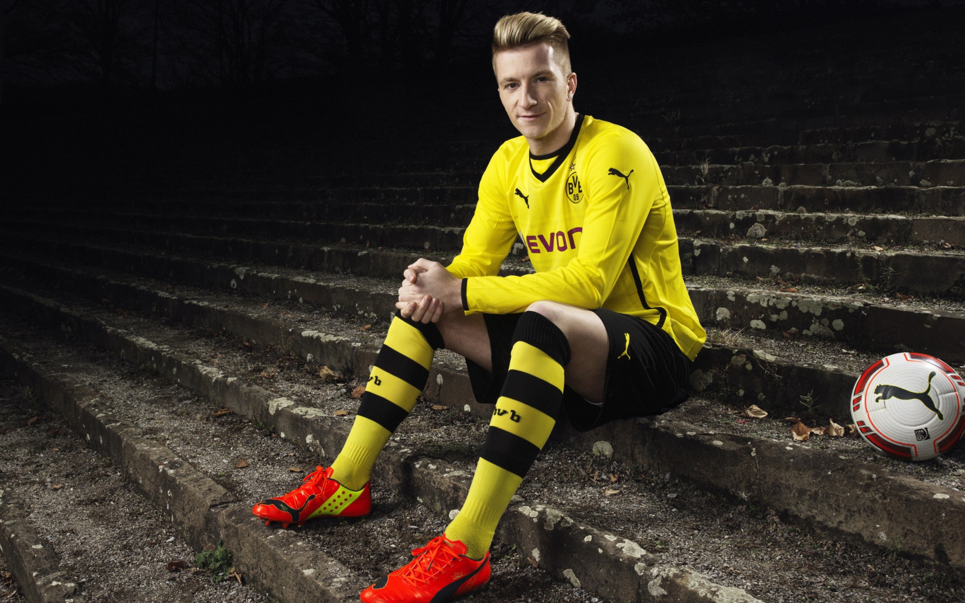 Немецкий футболист Марко Ройс сидит на ступеньках 