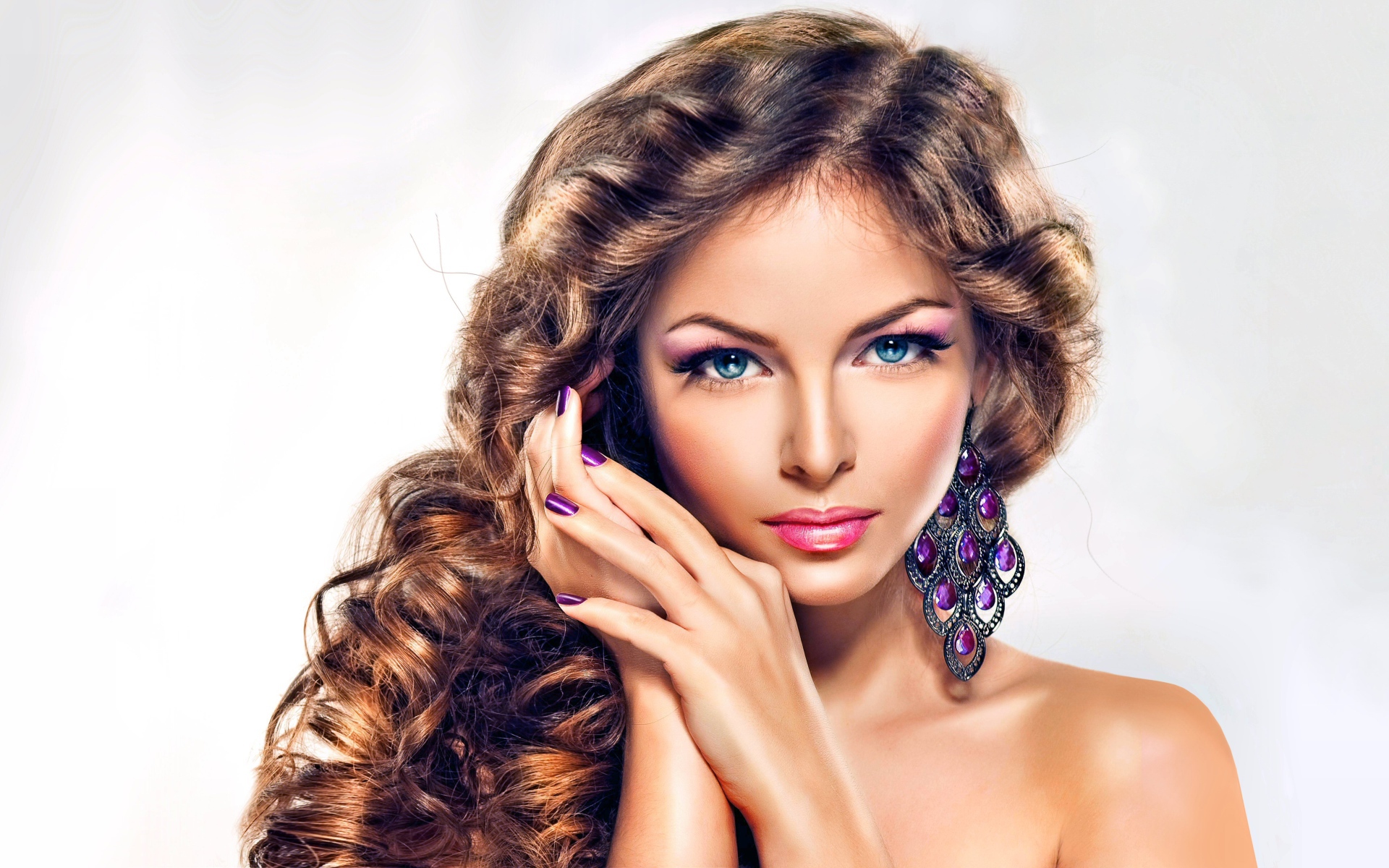 Beautiful blue-eyed long-haired brown-haired woman with beautiful earrings