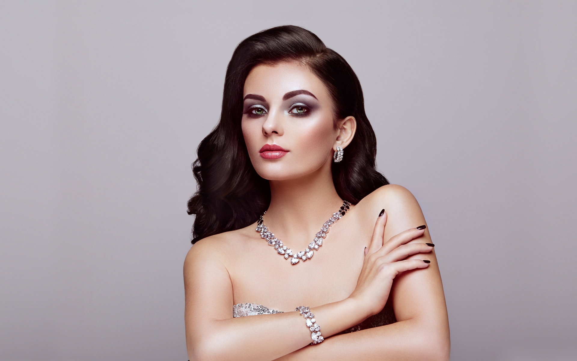 Красивая яркая брюнетка на сером фоне