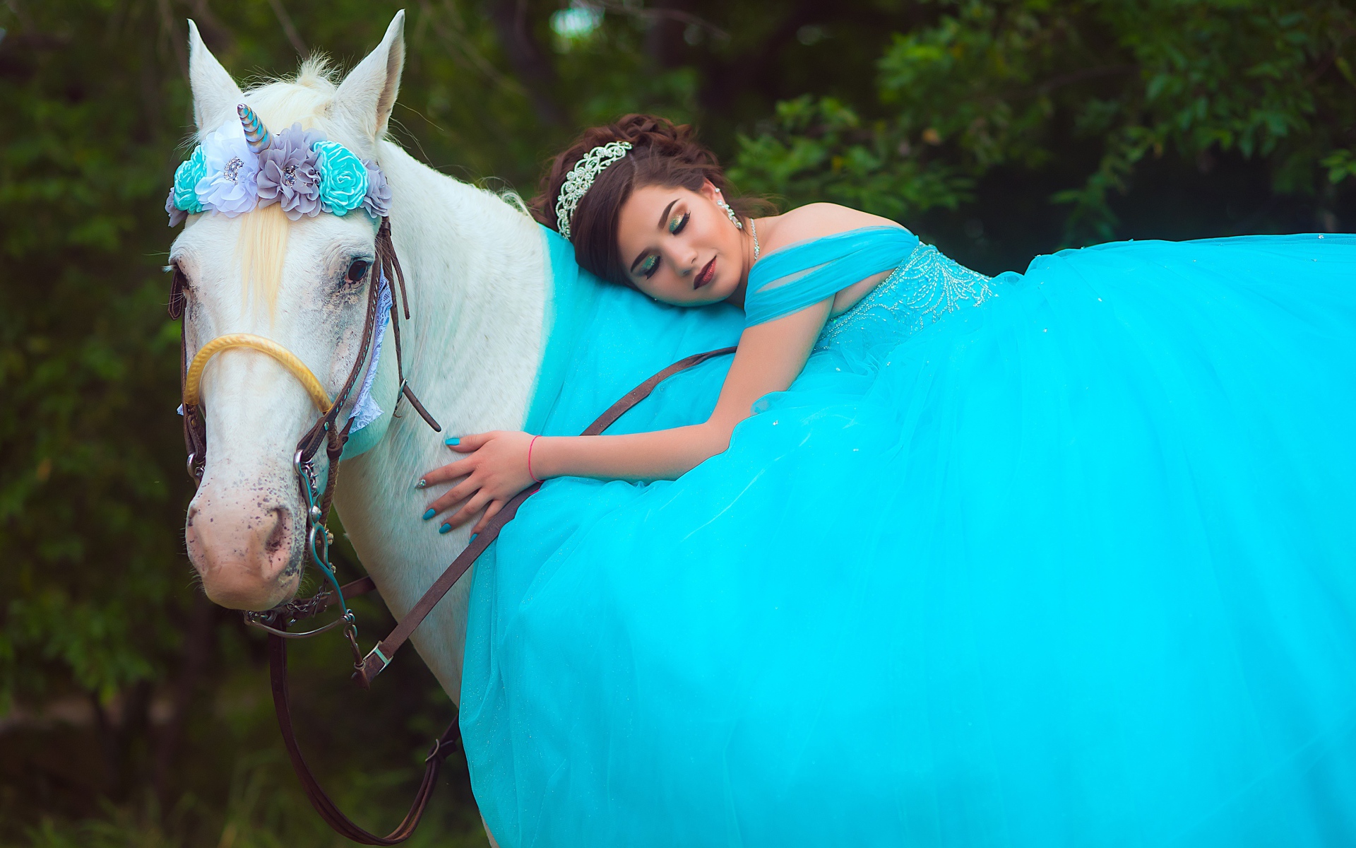 Красивая девушка в пышном голубом платье на лошади