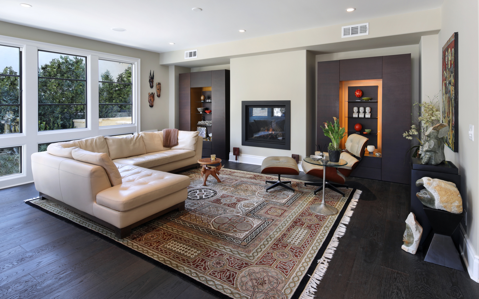 A stylish living room with a white leather sofa and carpet on the floor.