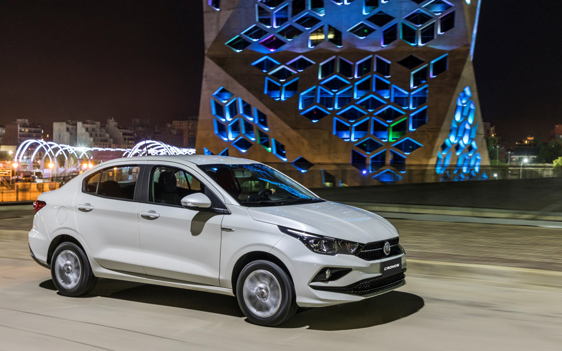 Белый автомобиль Fiat  Cronos, 2018 года на фоне здания