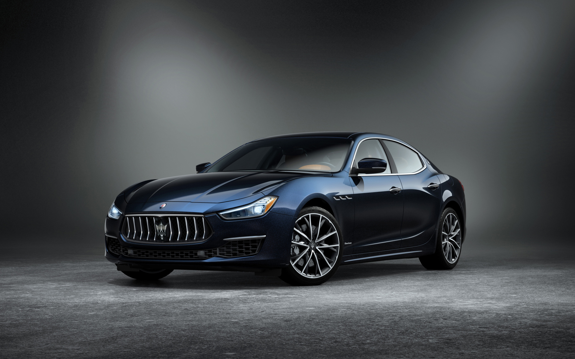 Автомобиль Maserati Ghibli GranLusso, 2019 года на сером фоне
