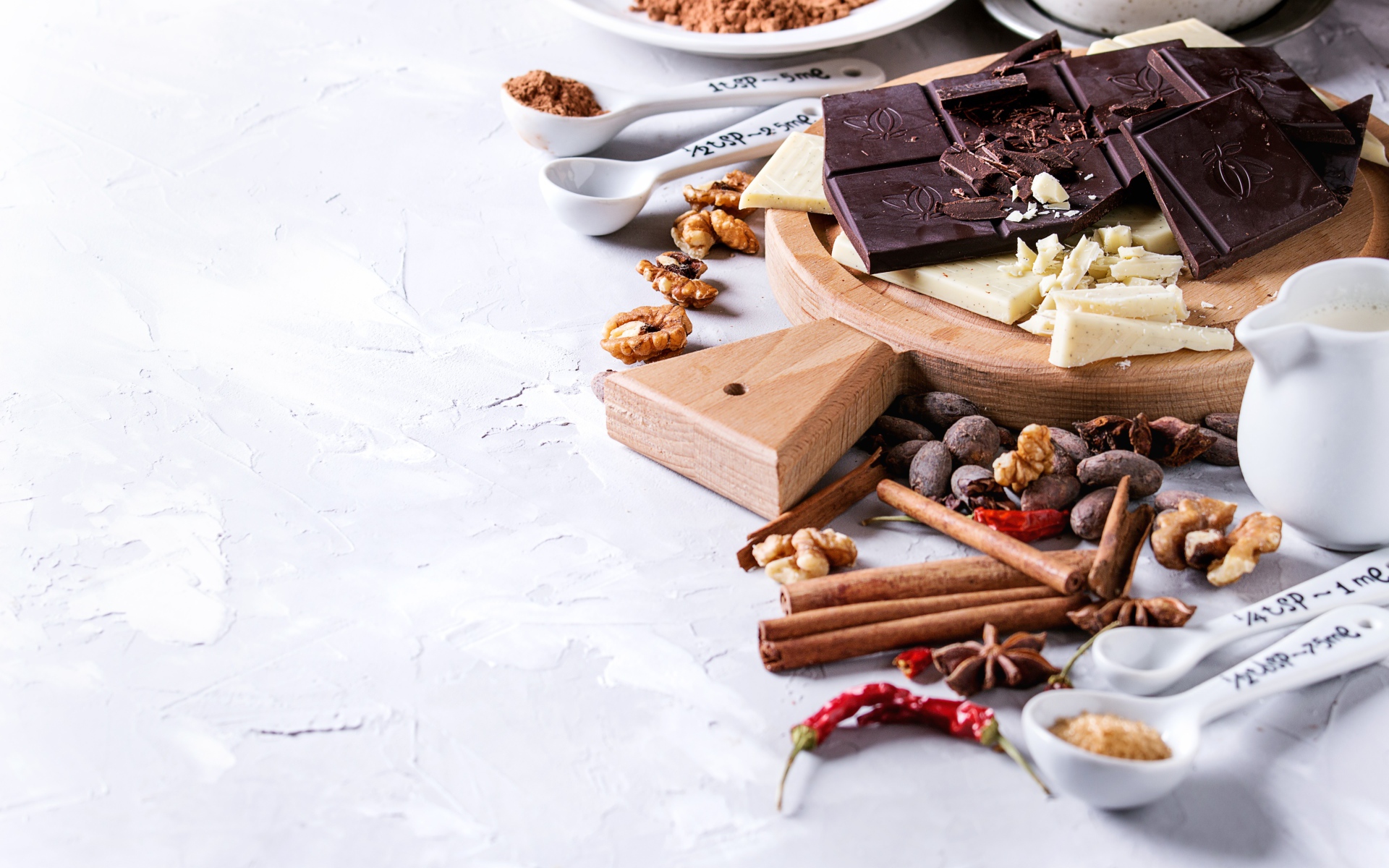 Черный и молочный шоколад на столе с орехами