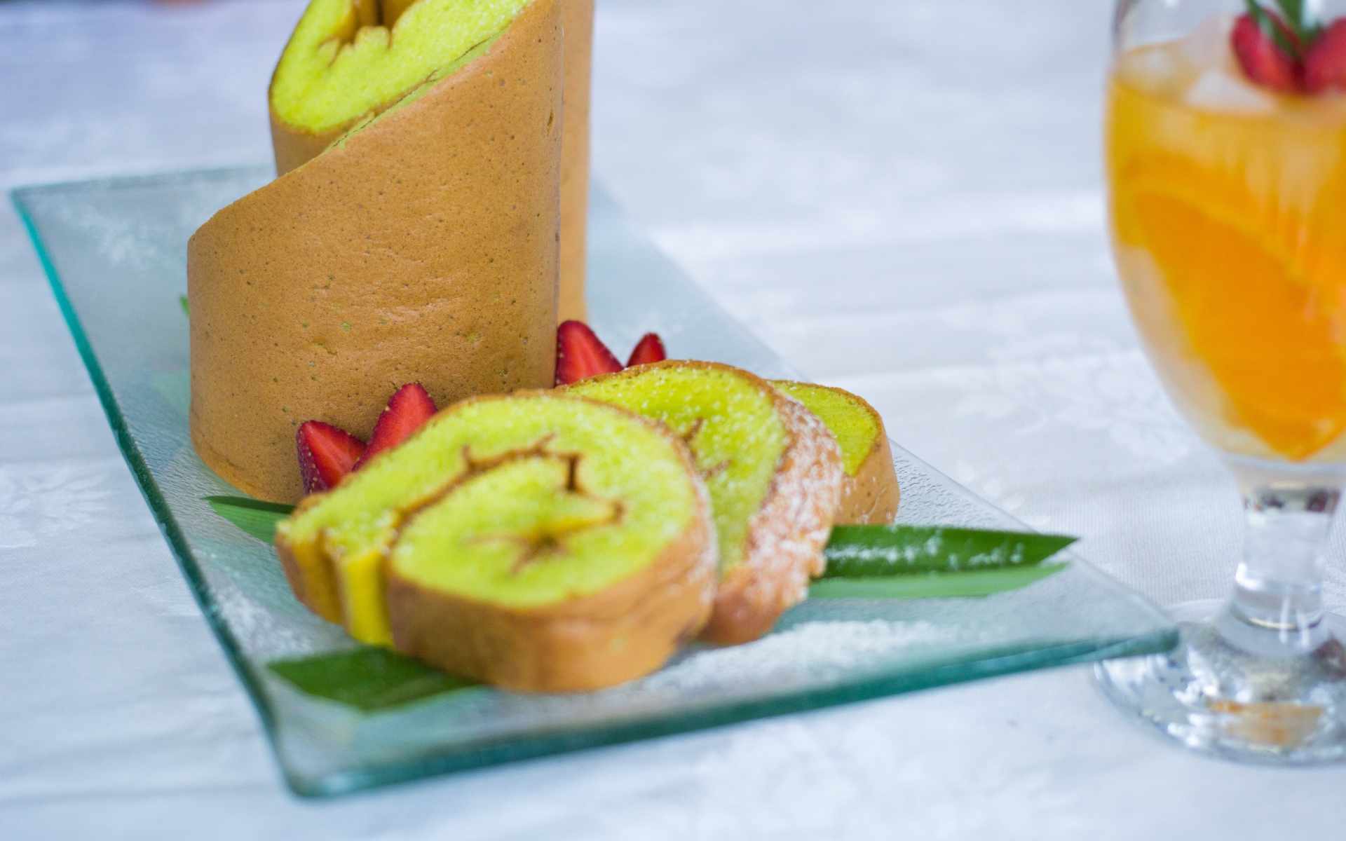 Рулет с сахарной пудрой и клубникой на столе