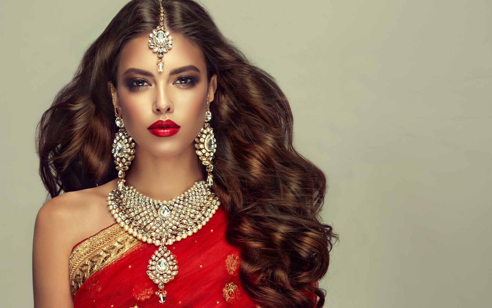 Красивая длинноволосая шатенка в индийском сари с украшениями