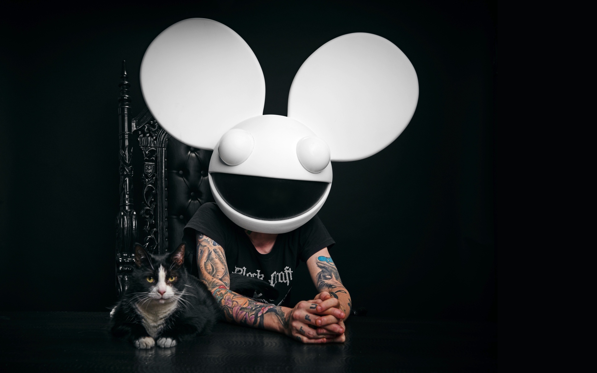 DJ Dedmaus with a cat on a black background