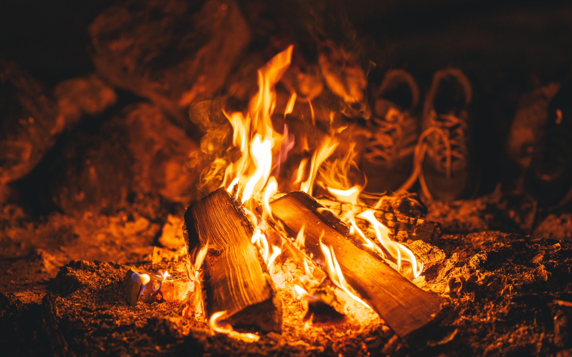 Firewood lies in the bright fire of a fire