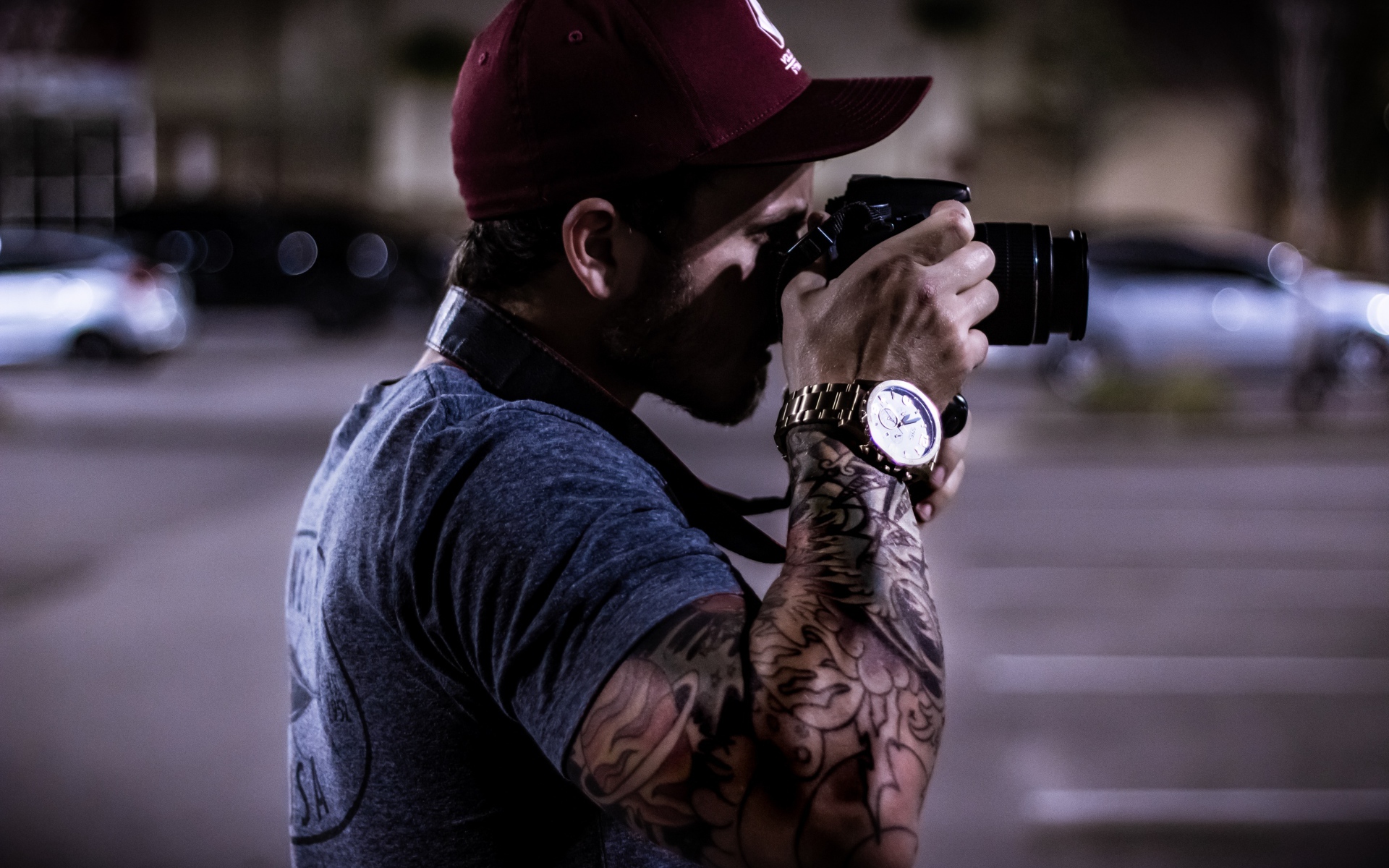 A man with a tattoo on his hand makes a photo