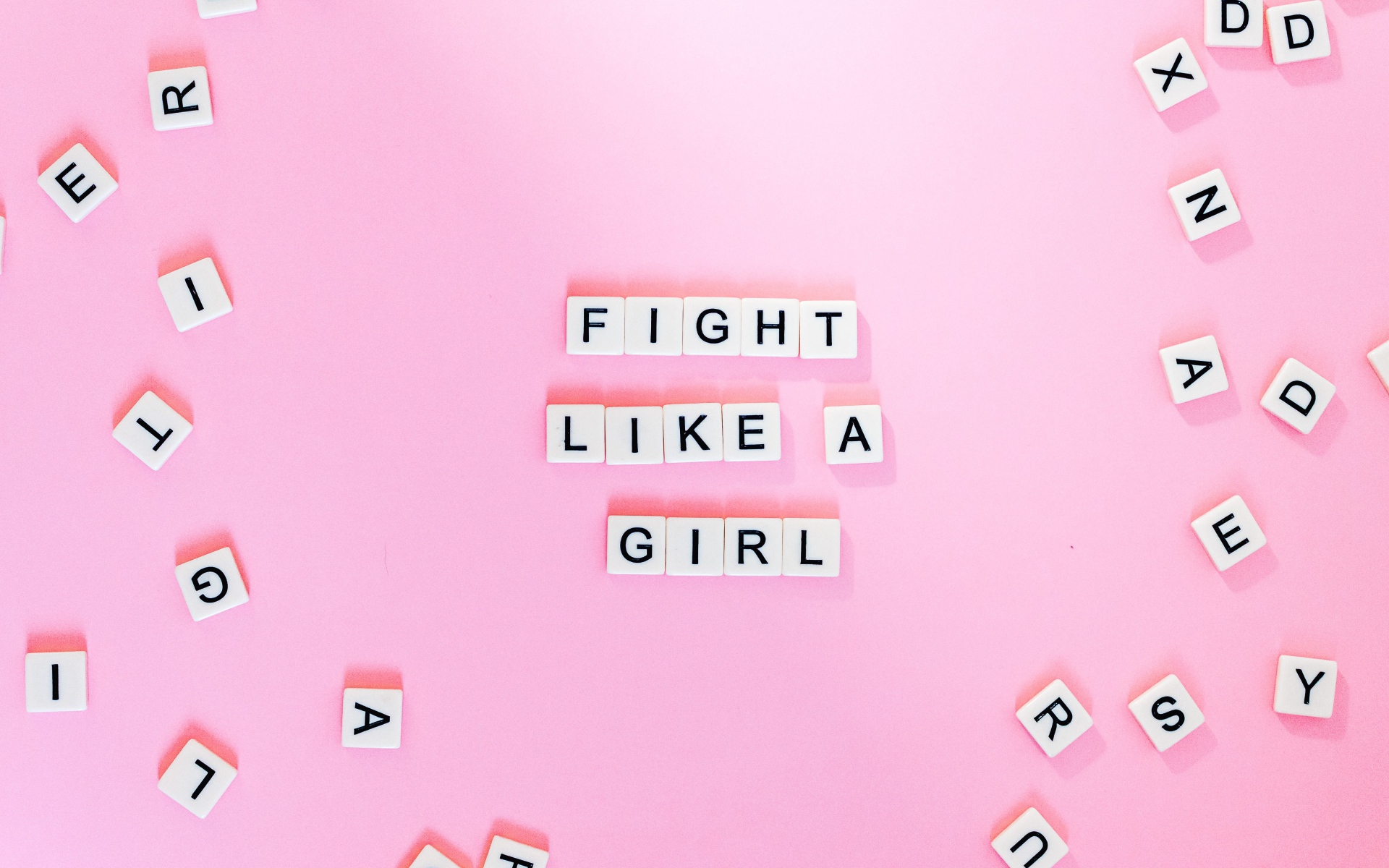 Cubes with the inscription Fight like a Girl on a pink background