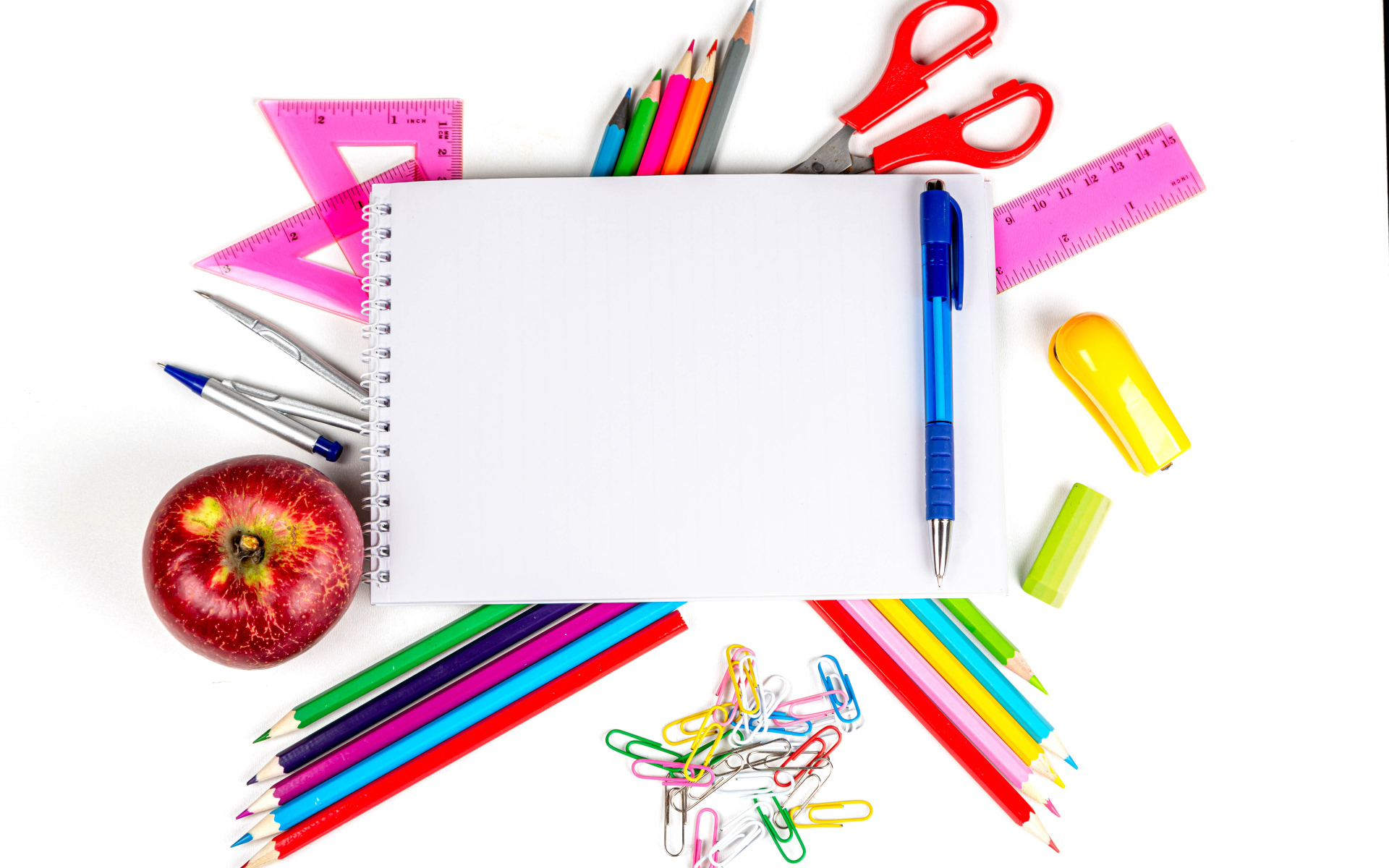 Office supplies on white background with notepad