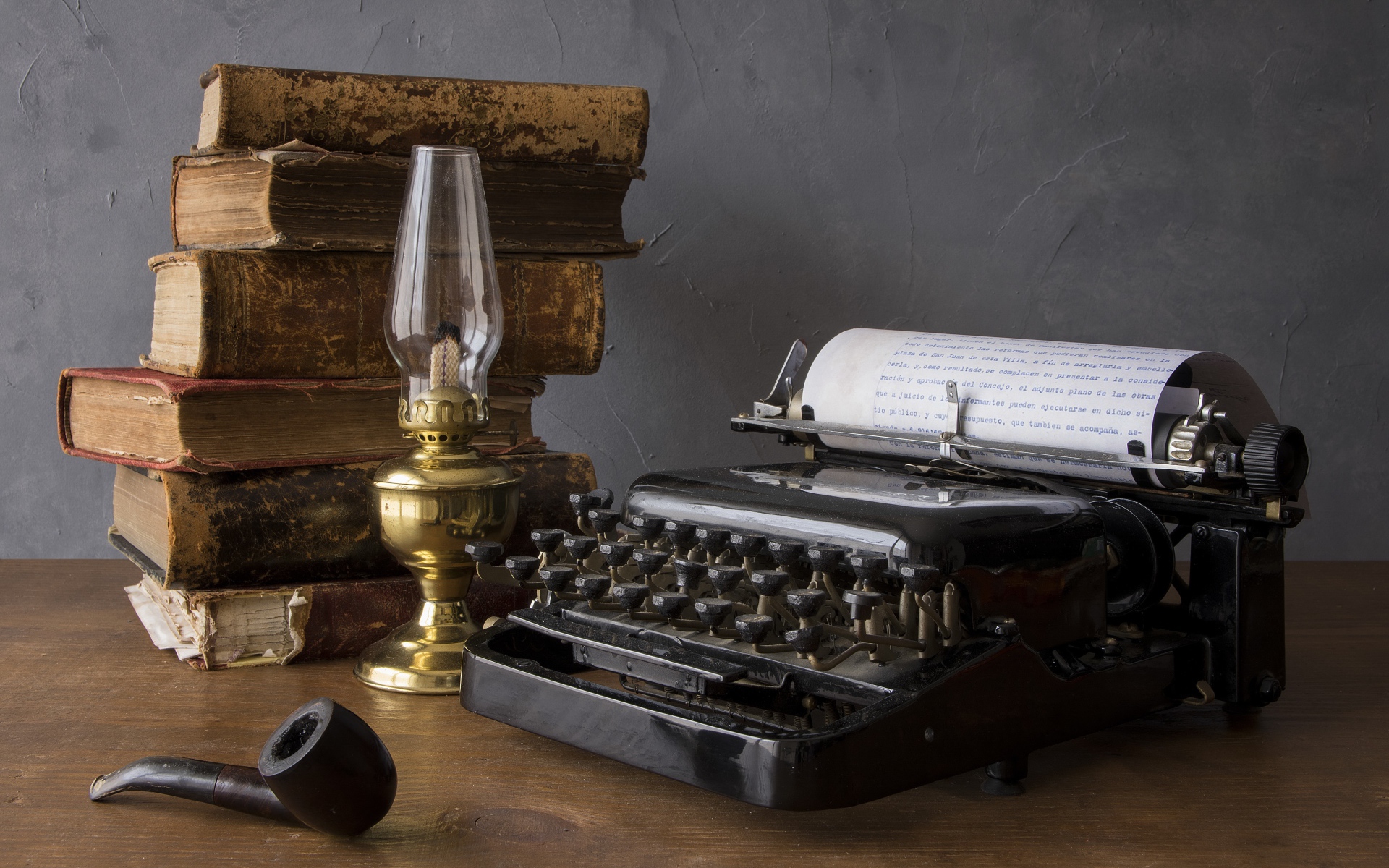 Old typewriter, books, kerosene lamp and tube on the table