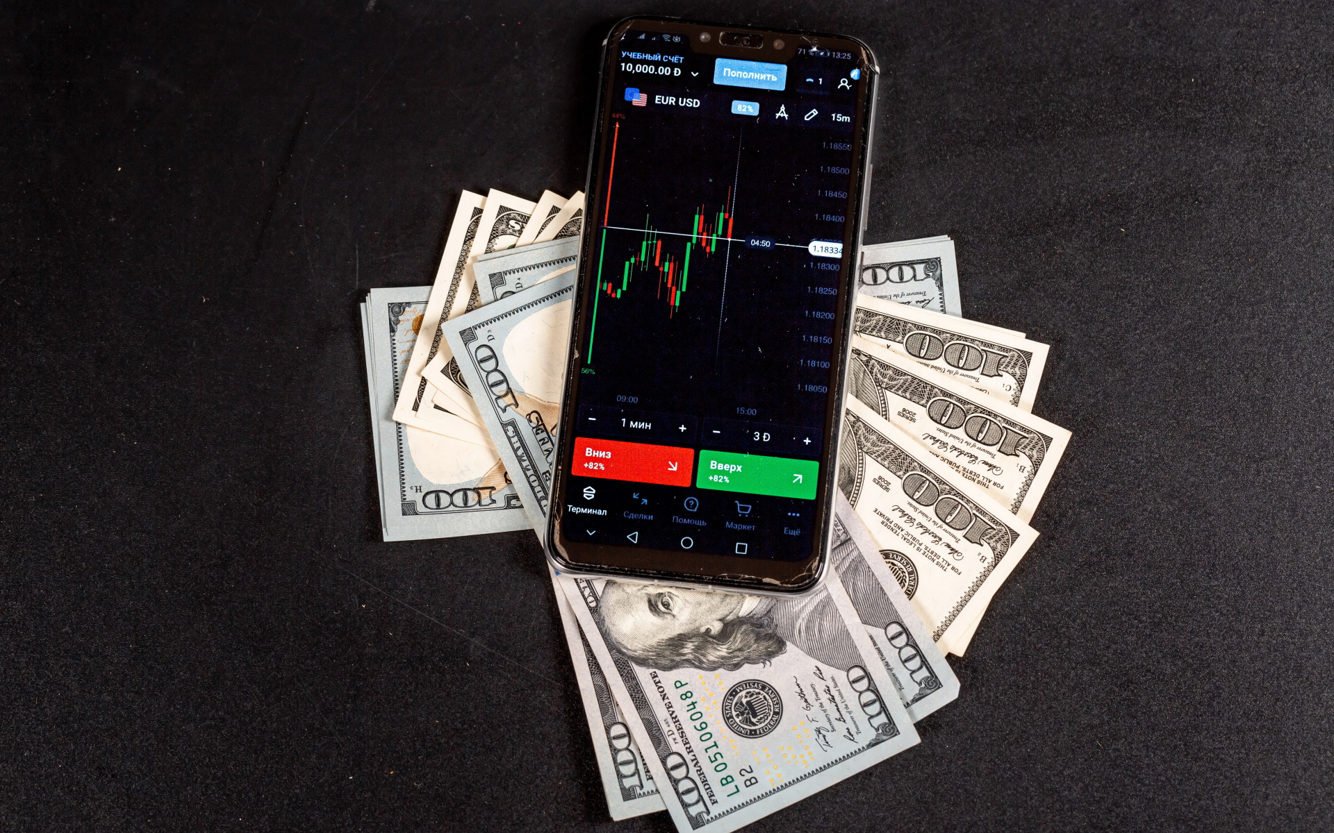 Доллары и смартфон на сером столе 