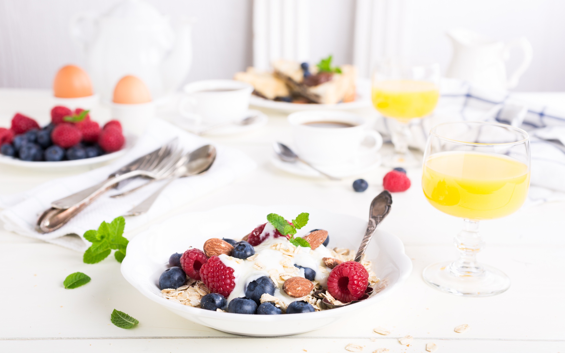 Oatmeal on a table with blueberries, raspberries and nuts