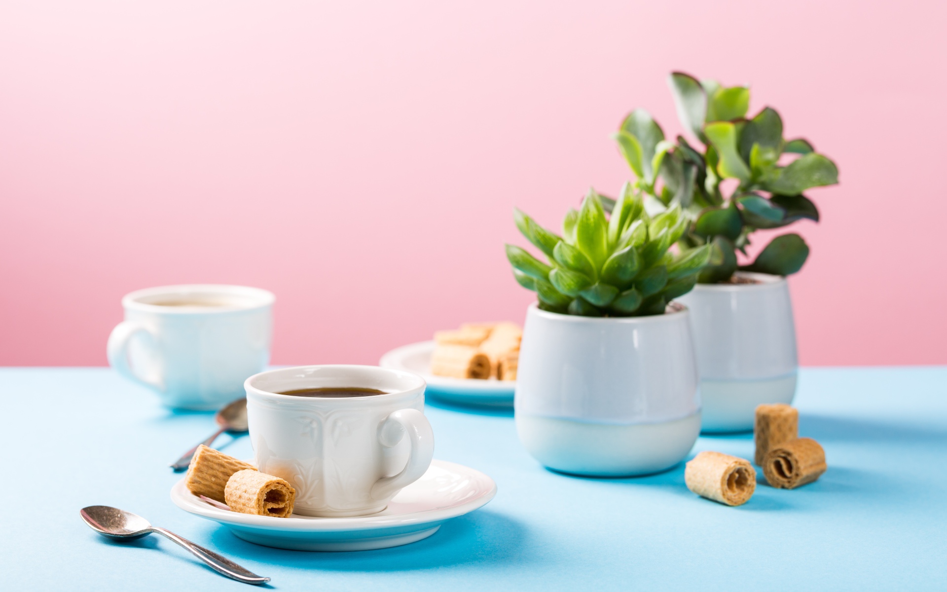 Чашка кофе на блюдце с вафлями на столе с цветами