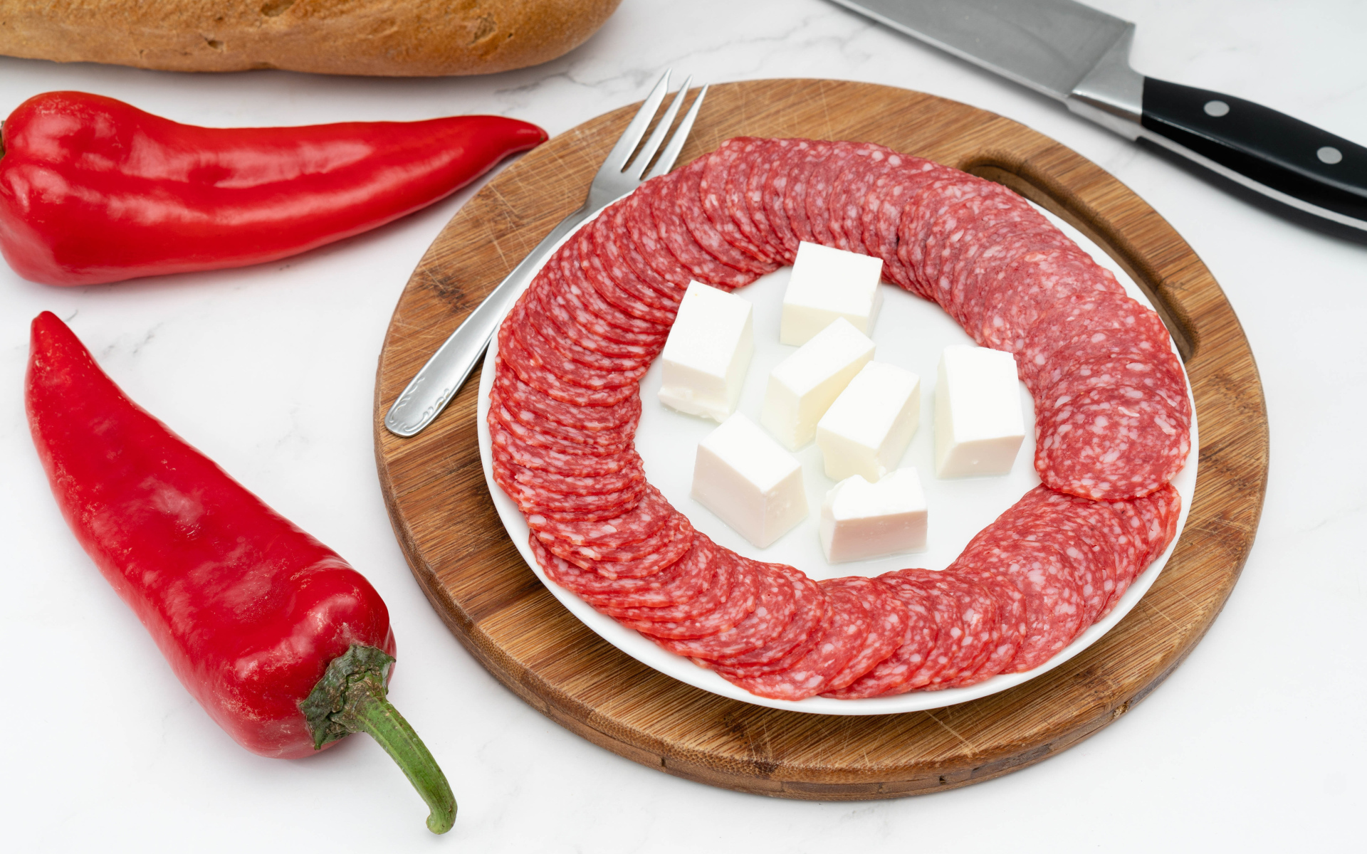 Колбаса с сыром на столе с красным сладким перцем