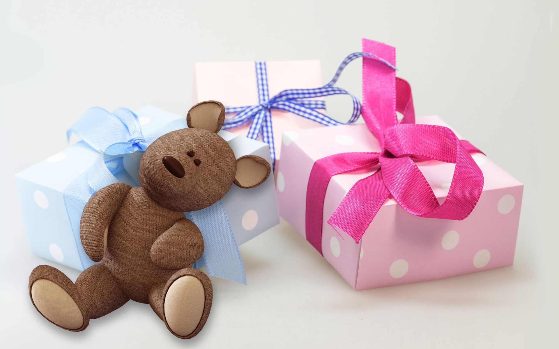 Gifts and teddy bear on a white background