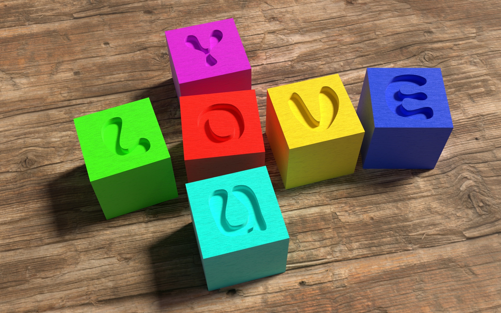 Разноцветные кубики с надписью Love  на деревянном столе 