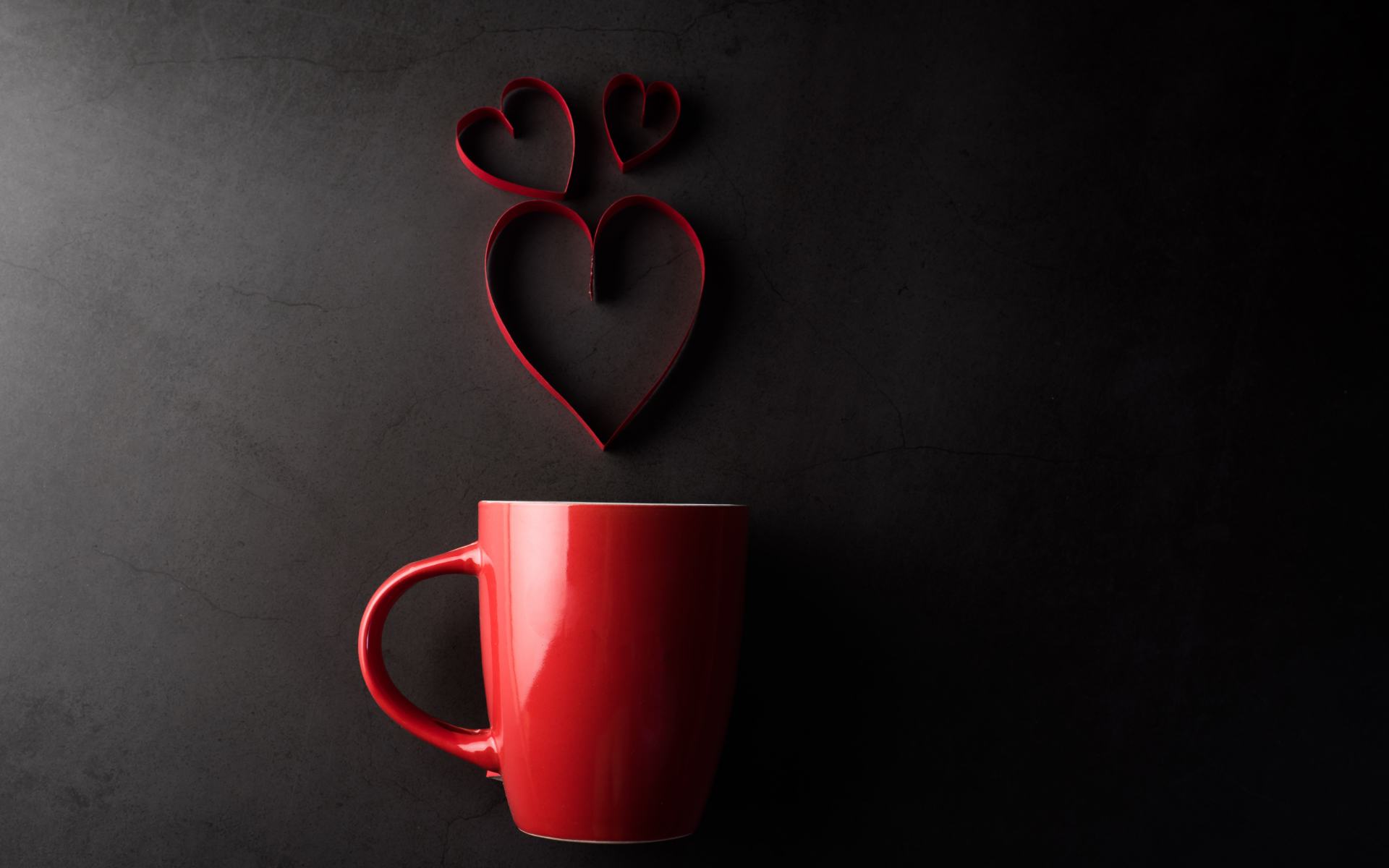 Red cup on a gray background with hearts