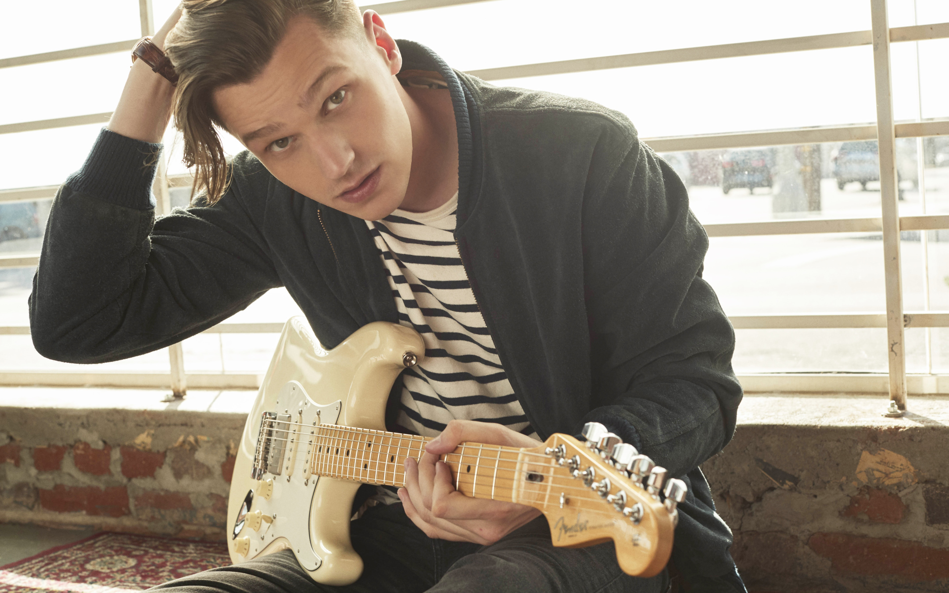 Певец Патрик Дрони с гитарой в руках