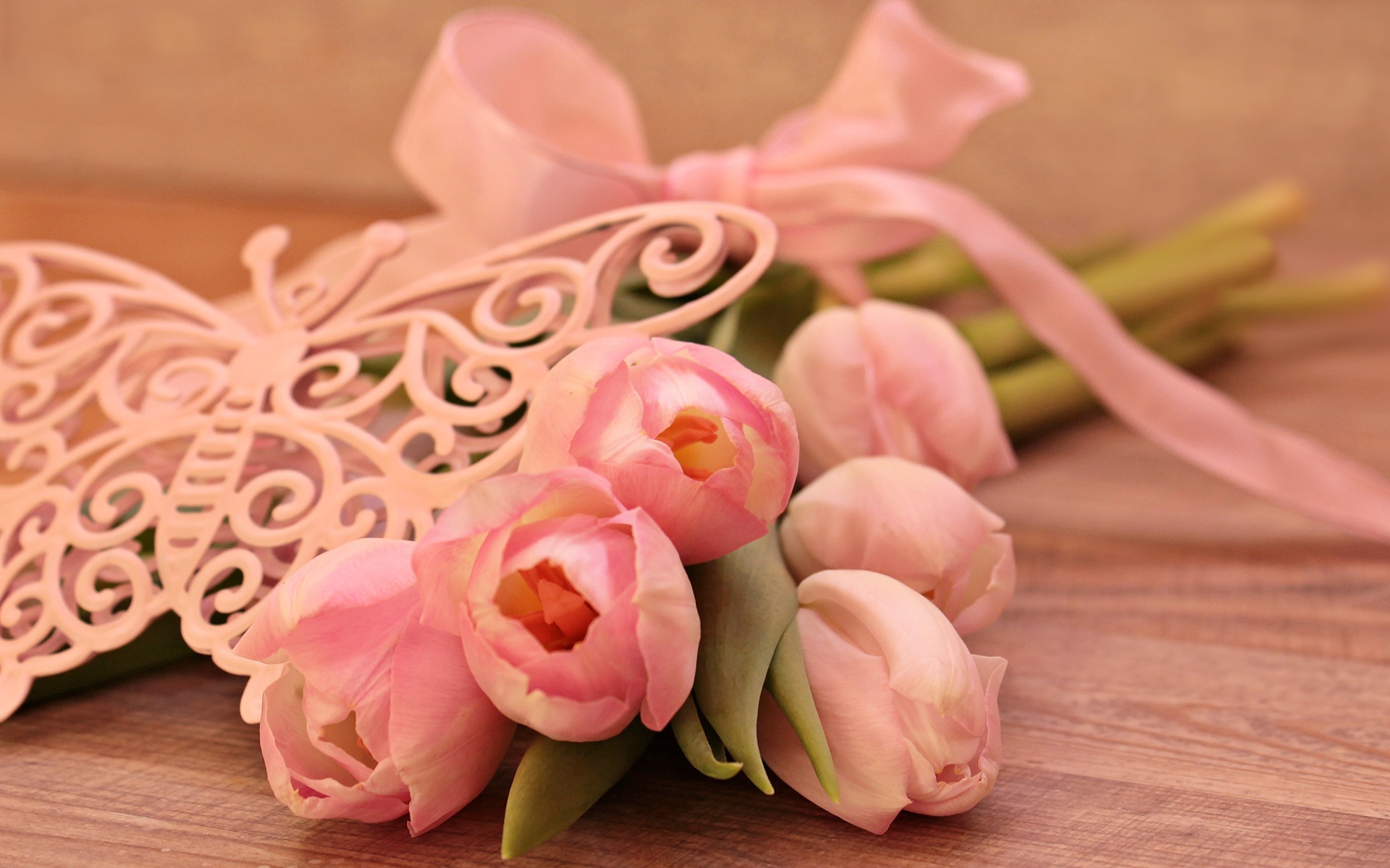 Bouquet of pink tulips with ribbon and butterfly