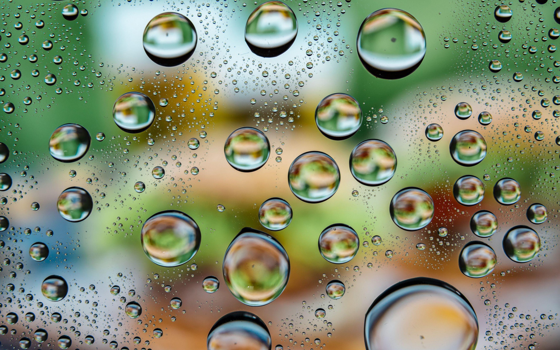 Big bubbles of water on glass