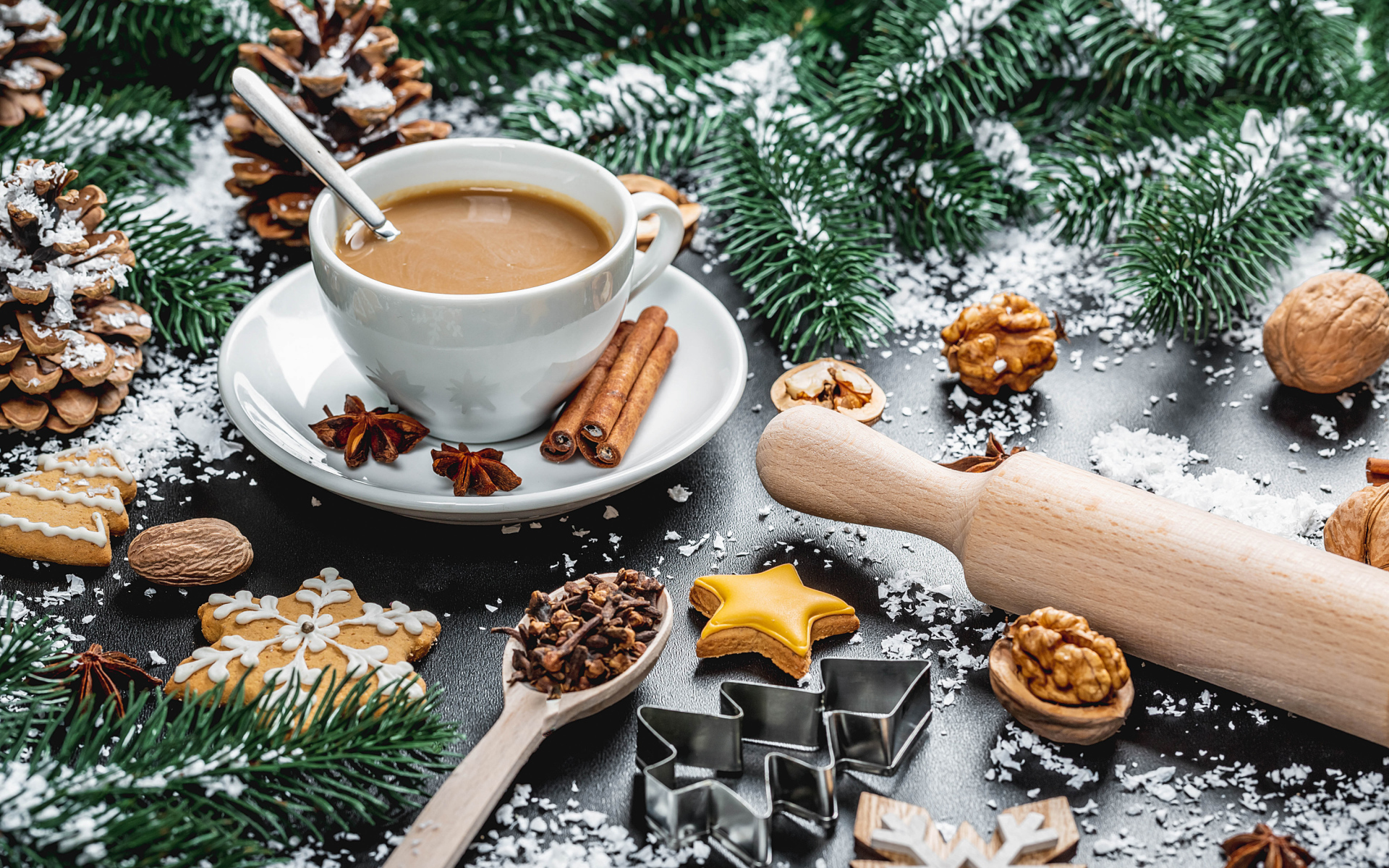 A cup of hot cocoa on the table with fir branches and nuts