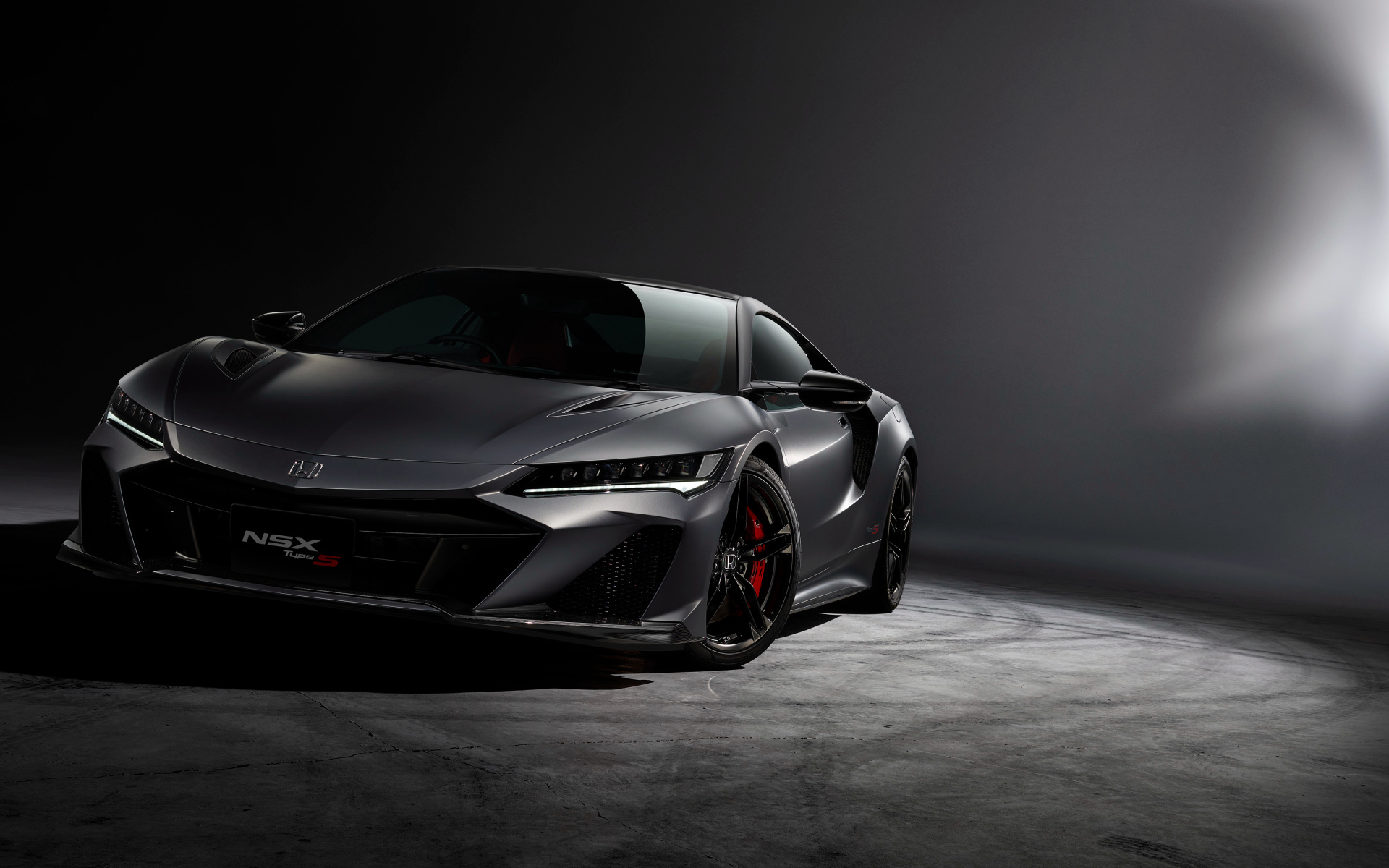 Серый быстрый автомобиль Honda NSX на сером фоне 