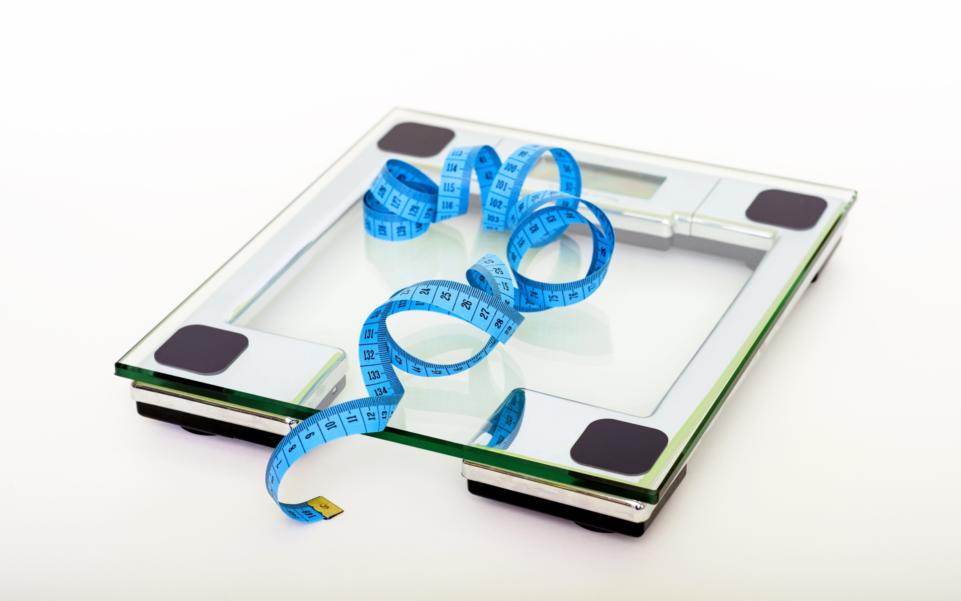 Bathroom scales and centimeter on white background