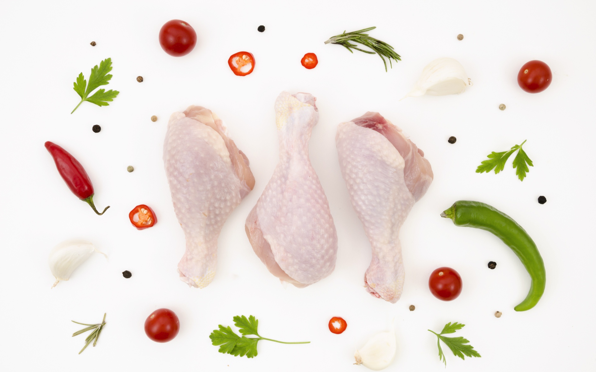 Fresh chicken thighs with peppers and tomatoes on a white background  Desktop wallpapers 1920x1200