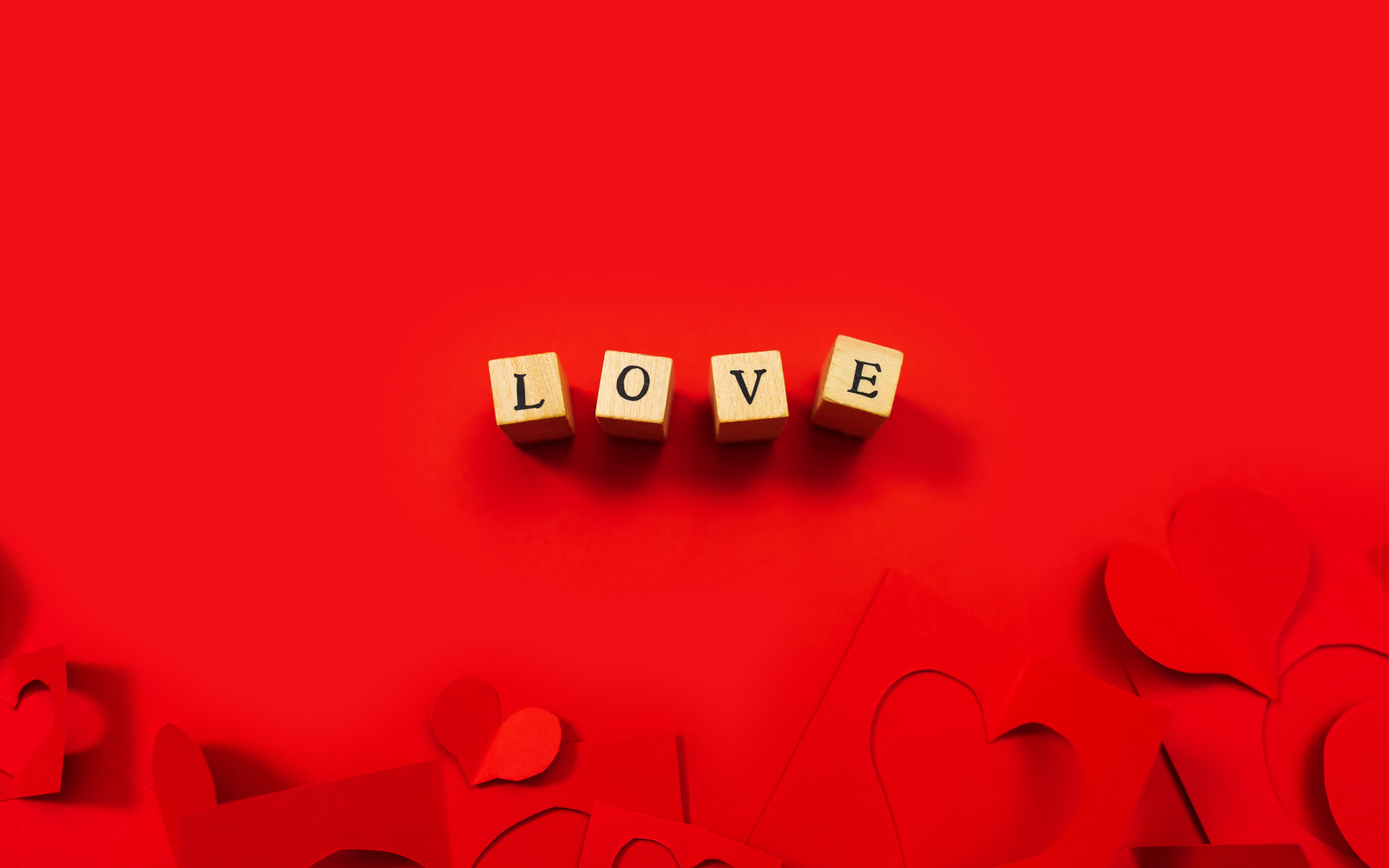 Wooden cubes with the inscription love on a red background