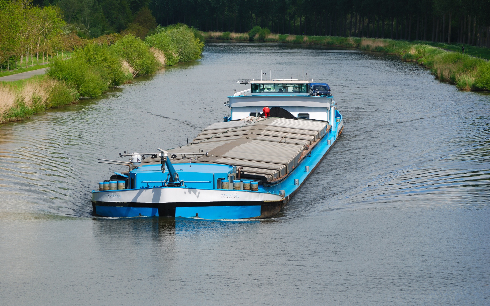 A cargo barge floats on the river