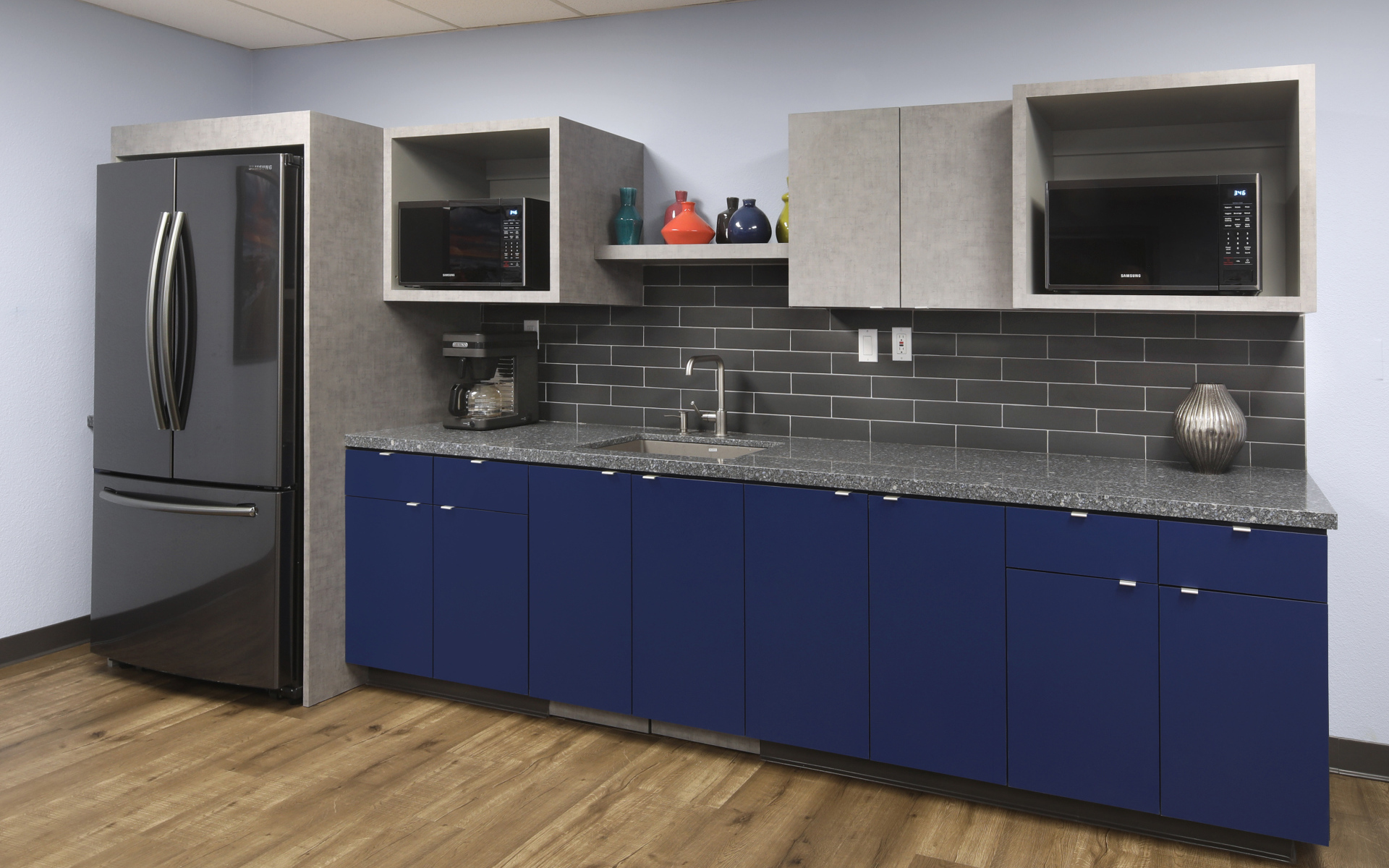 Синие шкафы и большой холодильник на кухне